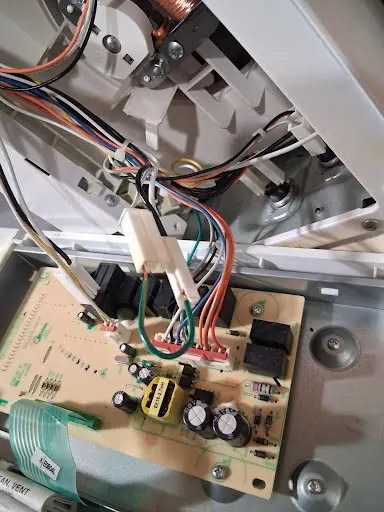 Appliance control board and wiring harness exposed for testing