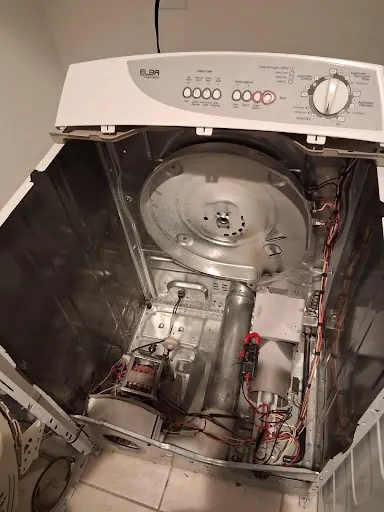 Dryer with the drum removed to replace worn parts