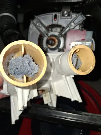 Washer drain pump clogged with debris pulled from the drain path